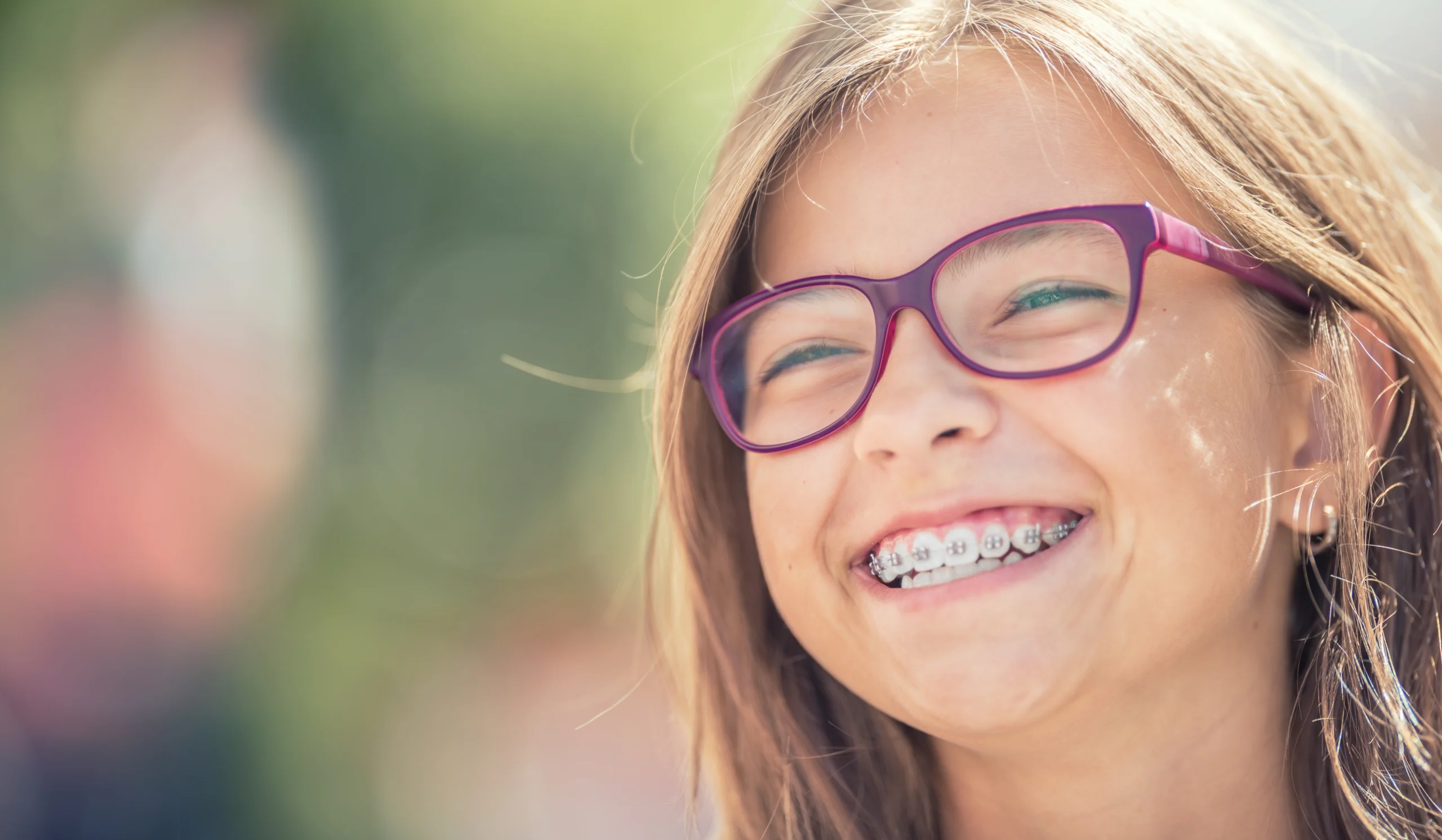 A smiling DentalPros braces patient